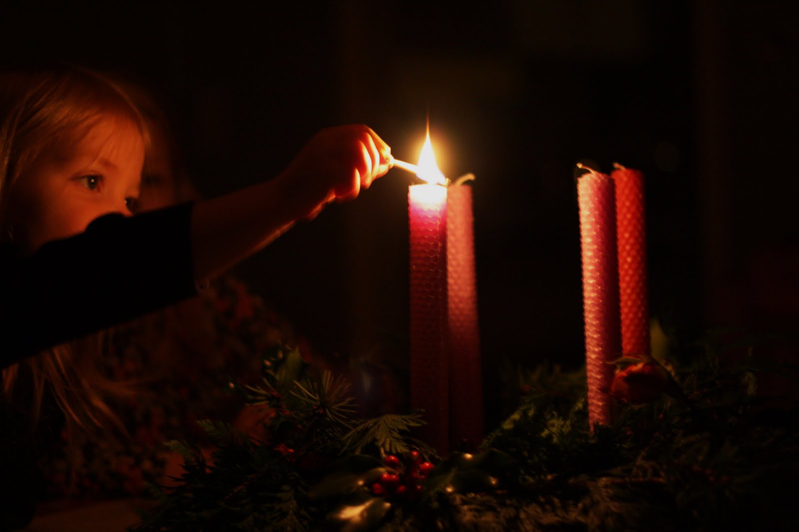Child lighting single advent candle