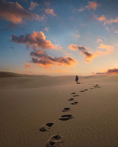 Foot steps on sand by Jesus walking in desert