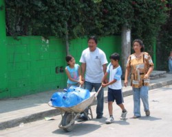St-Joseph-Church-Sister-Parish-Family-Using -Wheelbarrow-for- water